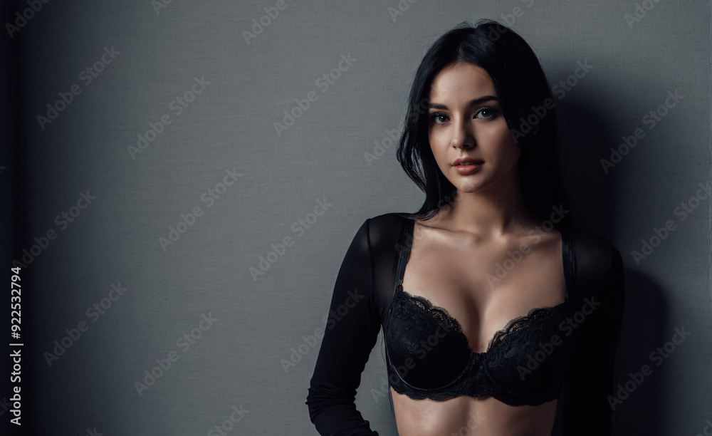Fashion model posing in studio on plain gray background. Portrait of young woman with black hair. Fashion model posing in studio on plain gray background. Portrait of young woman with black hair.