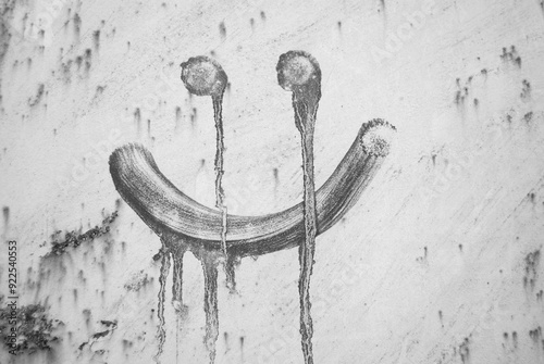 A smile painted with oil with splashes. Halloween illustration. Black and white horror face drawing with tears. Smiling and crying face. Halloween background.