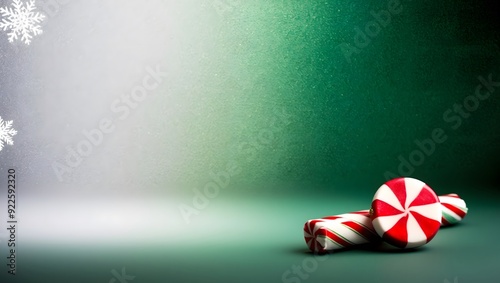 Festive peppermint candy on green gradient background with snowflakes