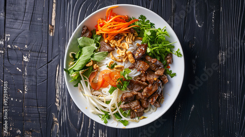 Vietnamese bun cha gio thit nuong: a delicious bowl of rice vermicelli noodles with grilled pork and fresh herbs