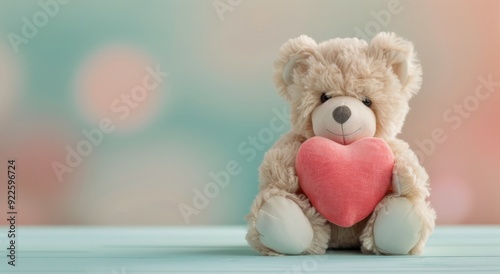 Adorable Teddy Bear Holding Pink Heart Against Soft Blue Background