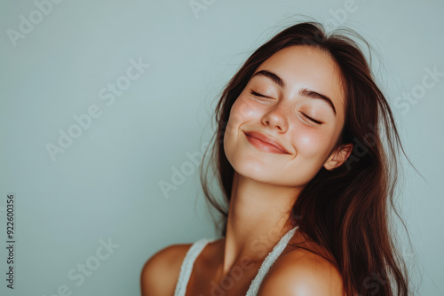 A close up of a woman's face with her eyes closed