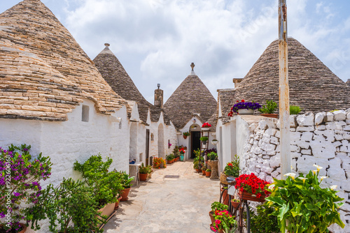 Famous historical old dry stone trulli houses with conical roofs in Alberobello, Italy.