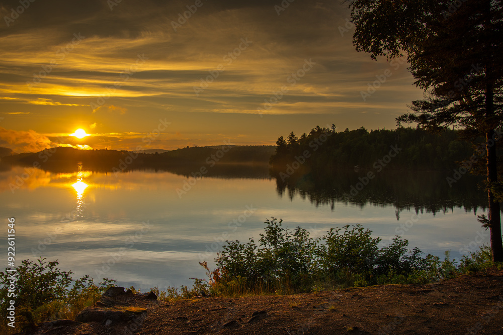 Fototapeta premium Sunset over a magnificent fishing lake in the Canadian forest
