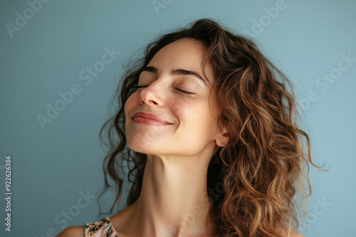 A close up of a woman's face with her eyes closed