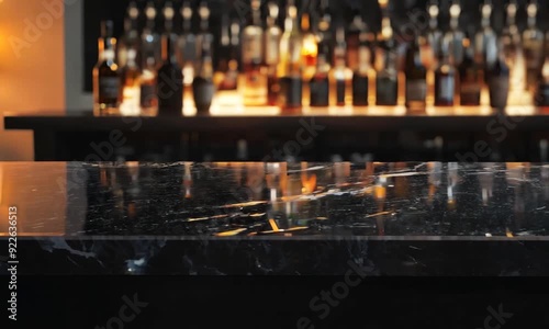 Black marble bar counter top with blank space product mockup. on dark blurred background of restaurant or bar