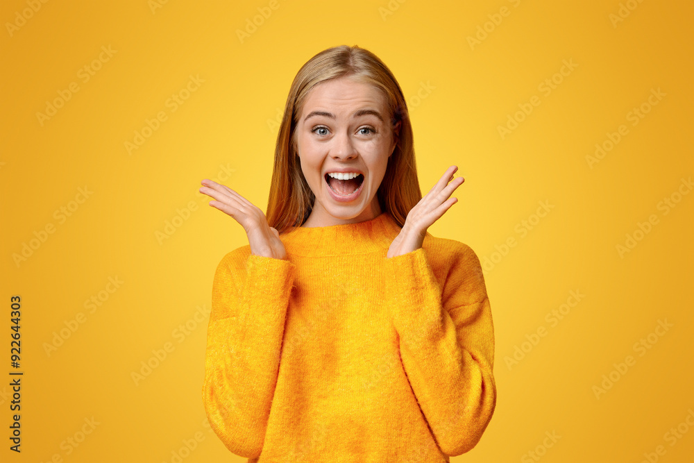 Wow. Surprised and shocked teen girl opened mouth in amazement over orange studio background Wow. Surprised and shocked teen girl opened mouth in amazement over orange studio background