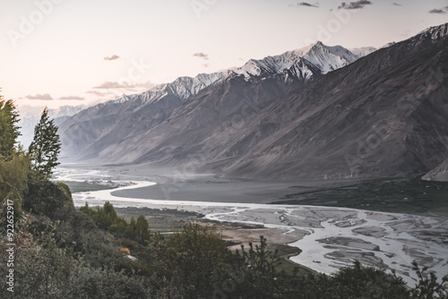 Panorama of the rocky mountain range of the Tien Shan with snow and glaciers and the Wakhan corridor with the Panj River in valley in the evening at sunset in the Pamirs in Tajikistan, for background photo