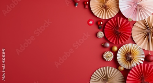 Festive Decorations With Paper Fans and Ornaments on Red Background