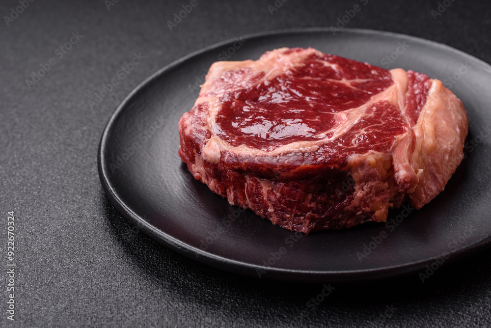 Fresh, raw beef steak with salt, spices and herbs Fresh, raw beef steak with salt, spices and herbs