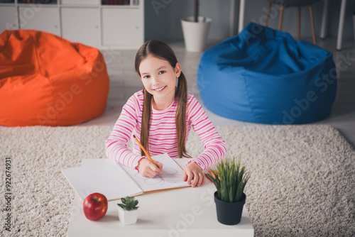 Photo portrait of cute small schoolgirl drawing art classes home education school interior