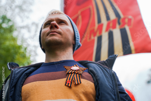 St. George's ribbon on the chest on the jacket in honor of Victory Day on May 9.  Togliatti, Russia - 9 May 2024 photo