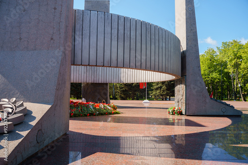 Eternal flame in the middle of red carnations and different colors, Victory Day holiday on May 9th in Russia. photo