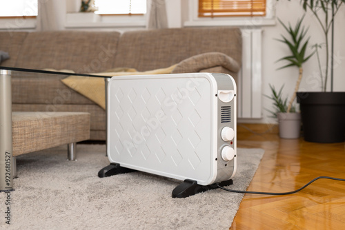 Fotografie Modern portable electric heater inside living room on carpet