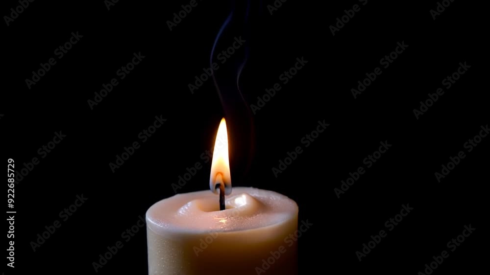 Candle burning on black background with light smoke, video Candle burning on black background with light smoke, video