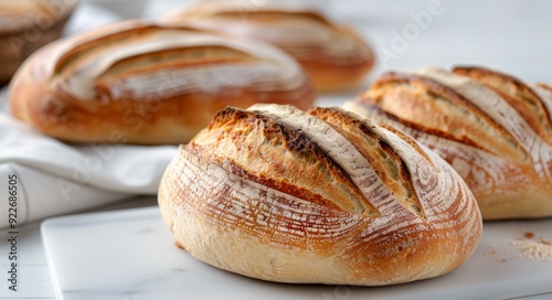 Freshly Baked Artisanal Bread Loaves on a White Surface