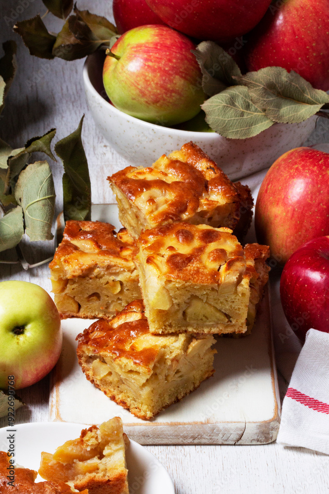Apple pie, apples and teapot served for tea. Traditional apple dessert.