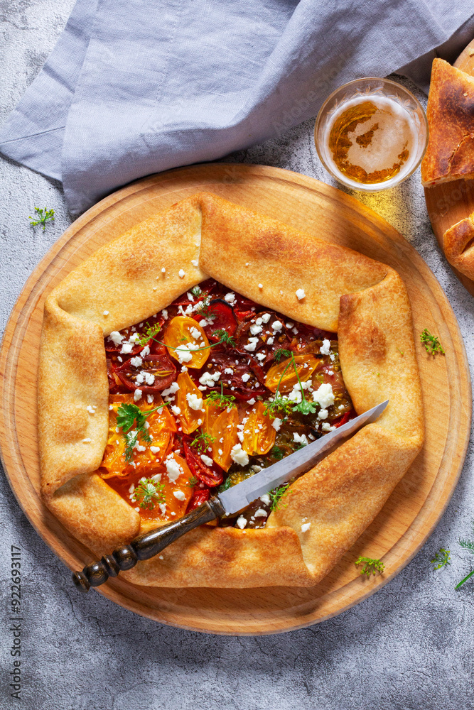 Traditional open pie galette with tomatoes, cheese and herbs, served with beer or wine.