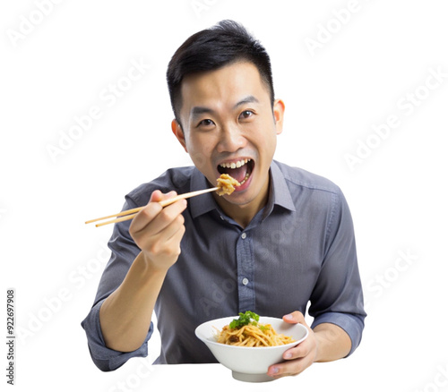 Young adult asian man is holding a bowl and eating with chopsticks