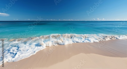 Sunny Beach With Gentle Waves and Clear Blue Sky
