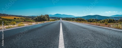 Endless Journey on Pristine Highway - Modern Travel Concept with Clear Blue Sky and Smooth Asphalt Stretching Into Horizon