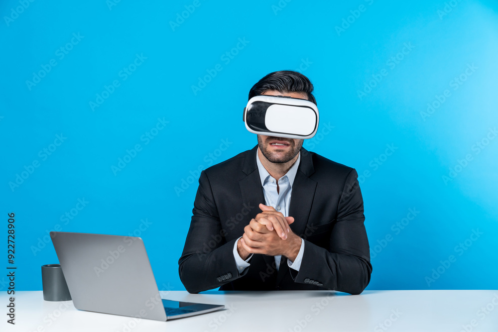 Business man sitting and opening laptop while wearing VR glass to enter metaverse. Smart manager using virtual reality headset to connect with data analysis to make decision for investment. Deviation. Business man sitting and opening laptop while wearing VR glass to enter metaverse. Smart manager using virtual reality headset to connect with data analysis to make decision for investment. Deviation.