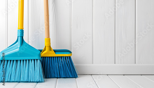 Cleaning broom and dustpan on wooden floor indoors