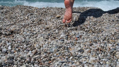 A children bare feet on a pebble beach