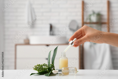Female hand with bottles of...