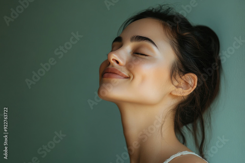 A close up of a woman's face with her eyes closed