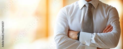Man in a white dress shirt with arms crossed