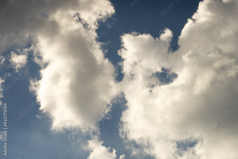 Grey clouds in a blue sky. A look at the sky.A white cloud above. Grey clouds in a blue sky. A look at the sky.A white cloud above.