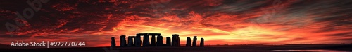 Winter Solstice Sunset Behind Stonehenge, a Majestic Display of Ancient Monuments Bathed in the Warmth of the Dying Day. photo