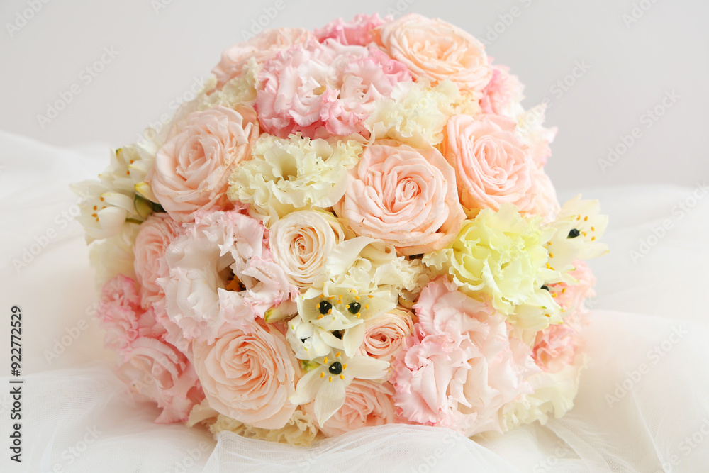 Beautiful wedding bouquet and bride's veil on light background Beautiful wedding bouquet and bride's veil on light background