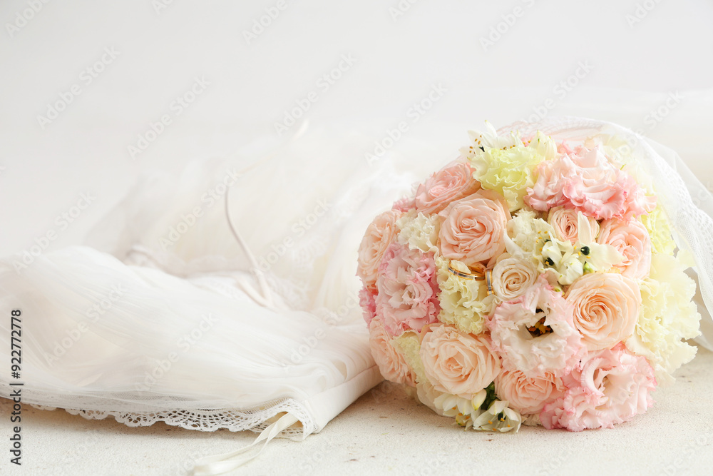 Beautiful wedding bouquet and bride's dress on light background Beautiful wedding bouquet and bride's dress on light background