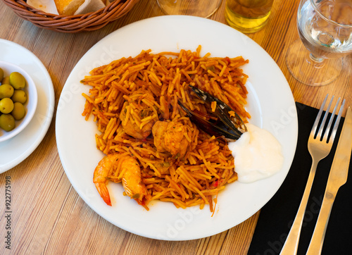 Traditional seafood fideua with mussels, shrimps and chicken photo