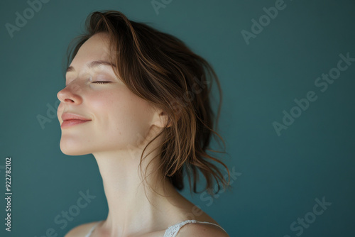 A close up of a woman's face with her eyes closed