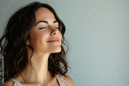 A close up of a woman's face with her eyes closed