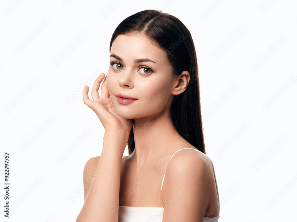 Beautiful young woman posing with hands on face, isolated on white background Beautiful young woman posing with hands on face, isolated on white background
