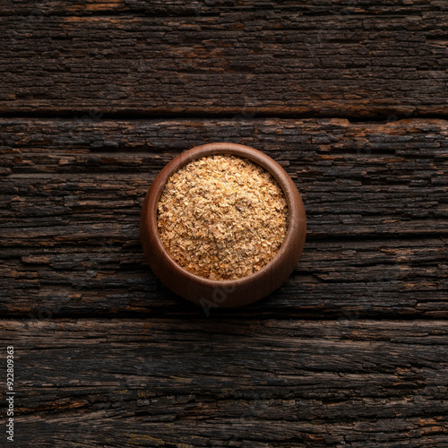 Soy fiber to cleanse the colon with psyllium in the bowl - Rustic wooden background photo