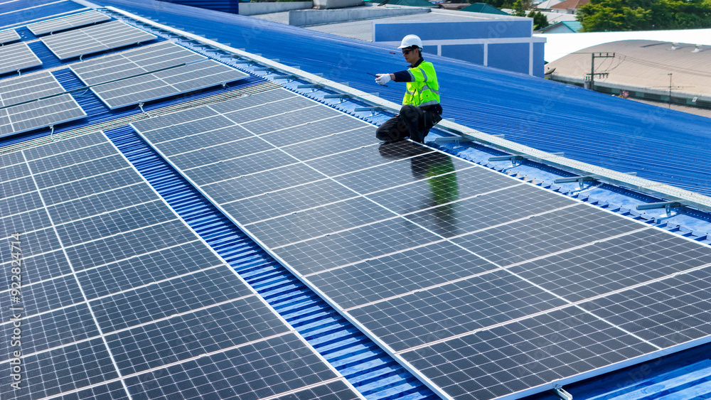 engineer man inspects construction of solar cell panel or photovoltaic cell by electronic device. Industrial Renewable energy of green power. factory worker working on tower roof. engineer man inspects construction of solar cell panel or photovoltaic cell by electronic device. Industrial Renewable energy of green power. factory worker working on tower roof.