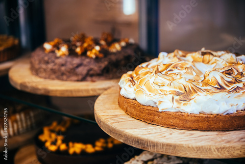 Lemon meringue cake and chokolate nut cake in sale in a bakery of a coffee shop. photo