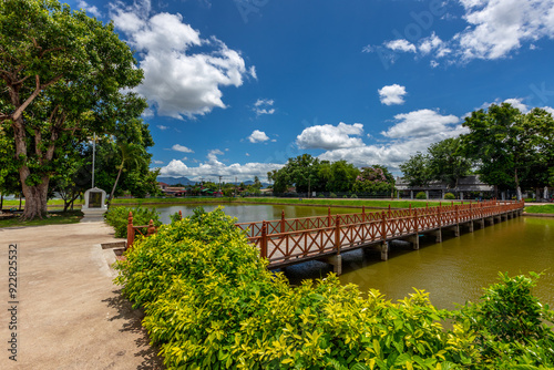 Background of Wat Traphang Thong, which is located in the middle of the water and has a wooden bridge, which is used to organize ceremonies (Loi Krathong, New Year) in Sukhothai province, Thailand.