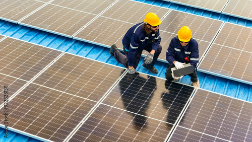 Wallpaper Mural Worker Technicians are working to construct solar panels system on roof. Installing solar photovoltaic panel system. Men technicians walking on roof structure to check photovoltaic solar modules. Torontodigital.ca