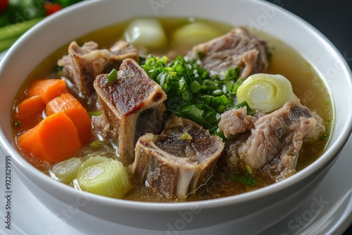 Sop Iga (Beef ribs soup) made from ribs, carrots, leeks. Served in white bowl. Indonesian food - generative ai