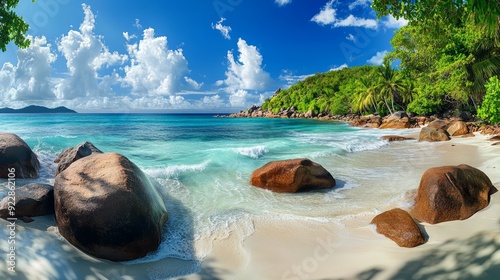 Stunning tropical beach from Anse Lazio in Seychelles. The view includes a pristine white sand beach surrounded by large, smooth granite boulders.