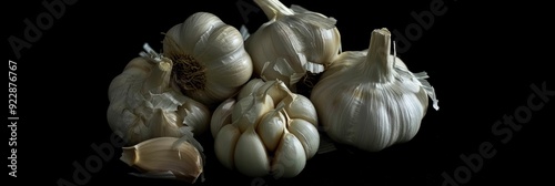 A collection of individual garlic cloves known for their value as a kitchen spice that boosts health benefits. photo