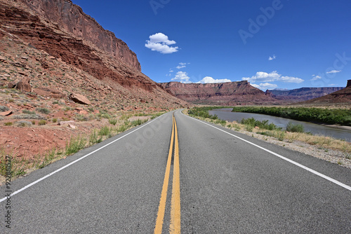 Red rock landscape along Utah State Route 128 near Moab on sunny summer afternoon.