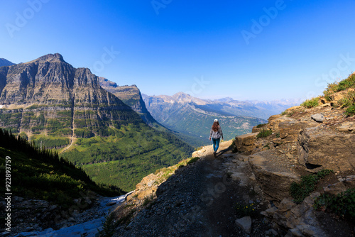 A woman hikes along the Highline Trail in Glacier National Park