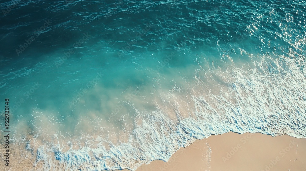 Azure Ocean Waves Crashing on Sandy Beach: An aerial view of turquoise ocean waves crashing onto a pristine sandy beach. Azure Ocean Waves Crashing on Sandy Beach: An aerial view of turquoise ocean waves crashing onto a pristine sandy beach.